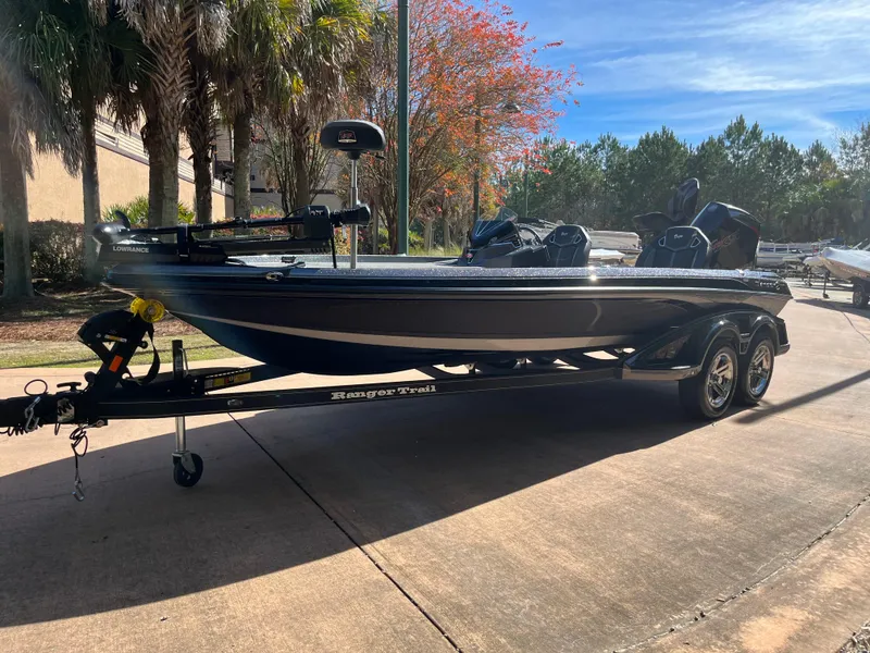 Slide: The Image of 2024 Ranger Z521R Ranger Cup Equipped boat on a trailer in a sunny outdoor setting. - 1
