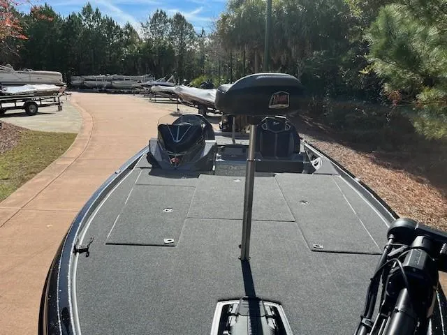 Slide: The Image of 2024 Ranger Z521R Ranger Cup Equipped boat on a trailer in a wooded area. - 4