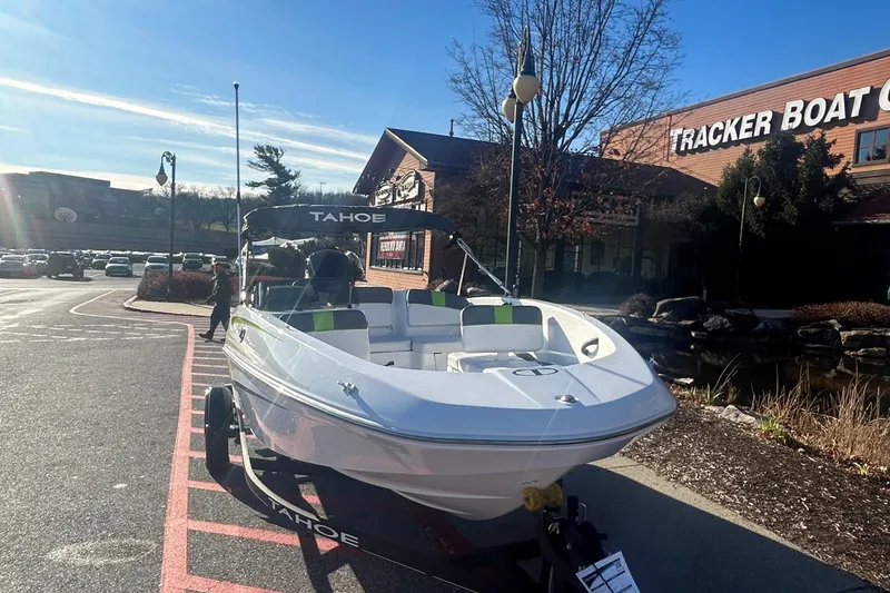 Slide: The Image of 2024 Tahoe T16 boat displayed outside Tracker Boat Center. - 2