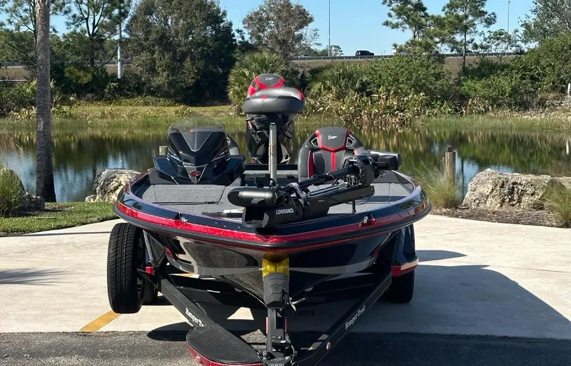Slide: The Image of 2024 Ranger Z521R Ranger Cup Equipped boat by a scenic lake. - 2