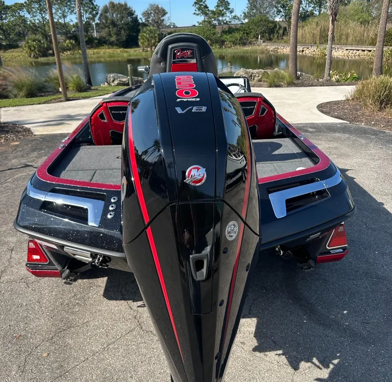 Slide: The Image of 2024 Ranger Z521R boat with powerful V8 engine, parked near a scenic lake. - 3