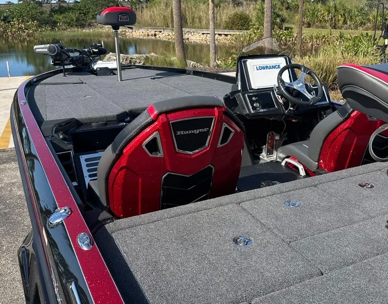 Slide: The Image of 2024 Ranger Z521R boat interior with red seats and Lowrance electronics. - 5