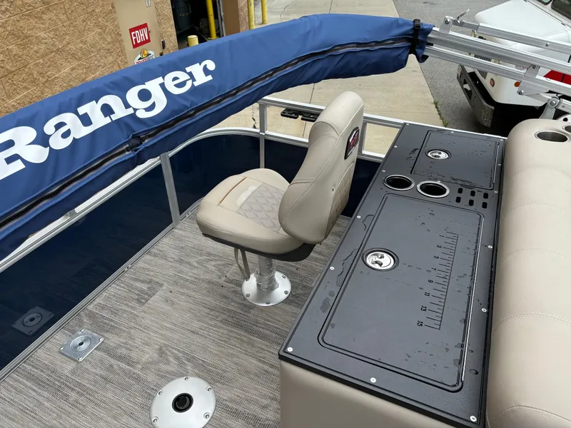 Slide: The Image of 2024 Ranger Reata 220FC boat interior with seating and control panel. - 5