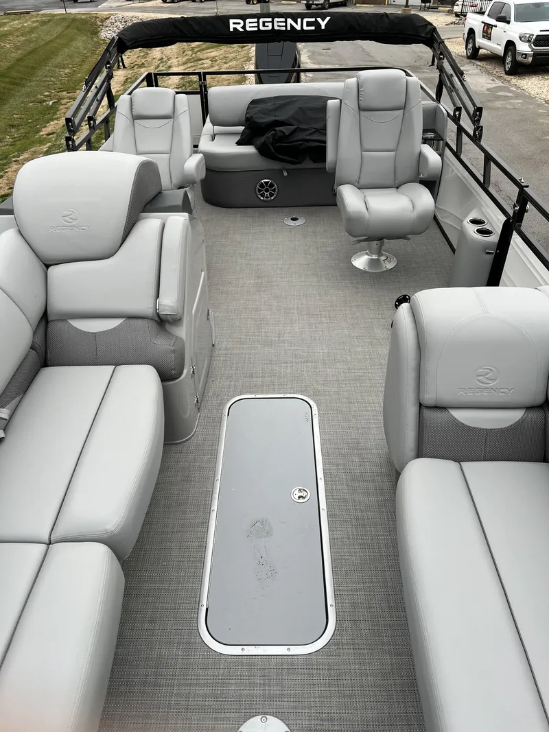 Slide: The Image of 2024 Regency 250 DL3 pontoon boat with spacious seating and modern design. - 10