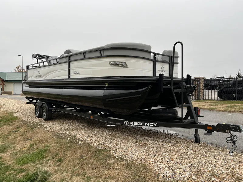 Slide: The Image of 2024 Regency 250 DL3 pontoon boat on trailer, side view. - 3