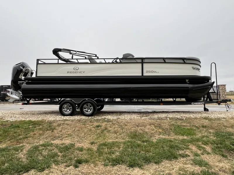 Slide: The Image of 2024 Regency 250 DL3 pontoon boat on a trailer, side view. - 4