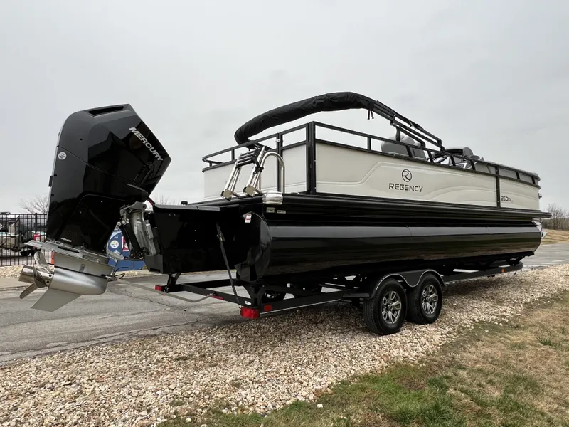 Slide: The Image of 2024 Regency 250 DL3 pontoon boat on a trailer, rear view. - 5