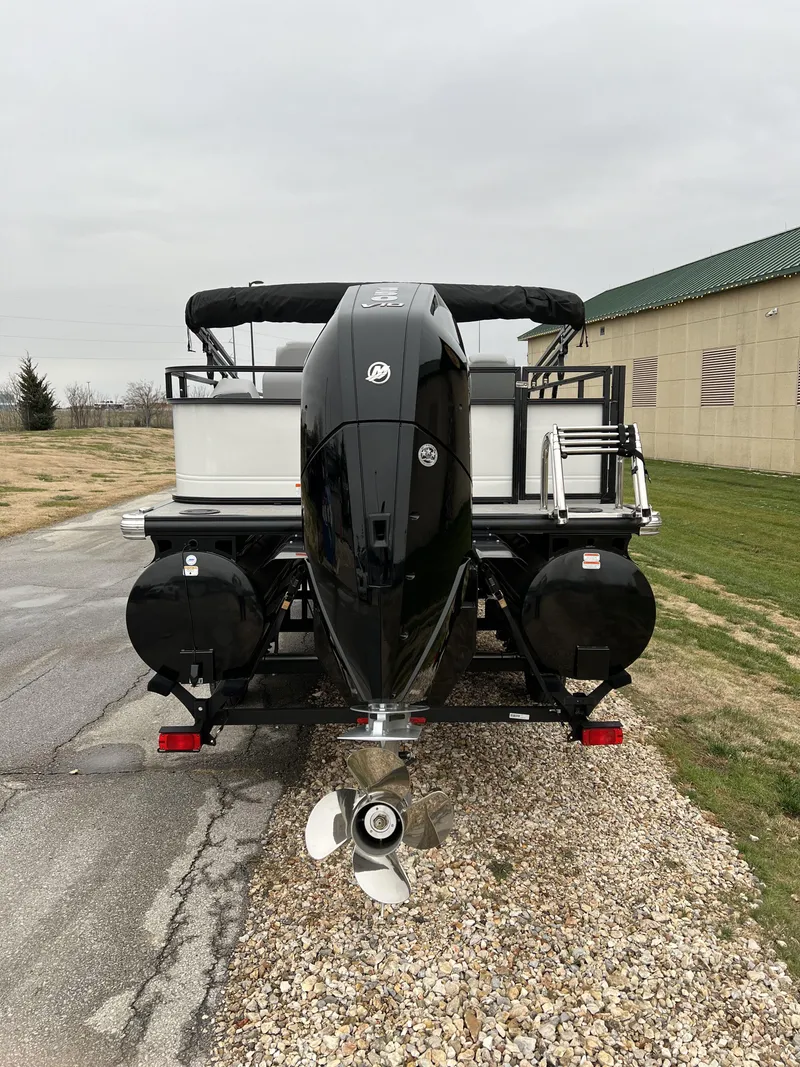 Slide: The Image of 2024 Regency 250 DL3 pontoon boat with outboard motor, rear view. - 6