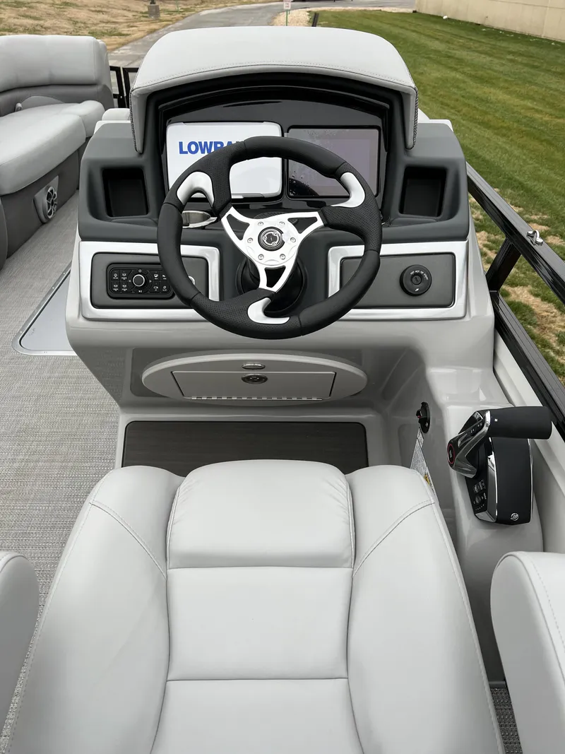 Slide: The Image of 2024 Regency 250 DL3 boat cockpit with steering wheel and control panel. - 8