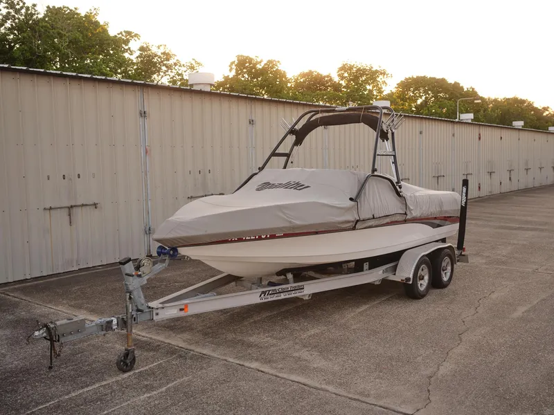 Slide: The Image of 2003 Malibu Sunscape 21 LSV boat on a trailer with a protective cover. - 16