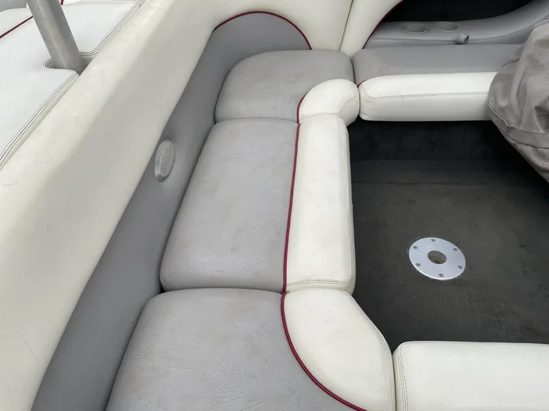 Slide: The Image of 2003 Malibu Sunscape 21 LSV boat interior seating with white and gray upholstery. - 17