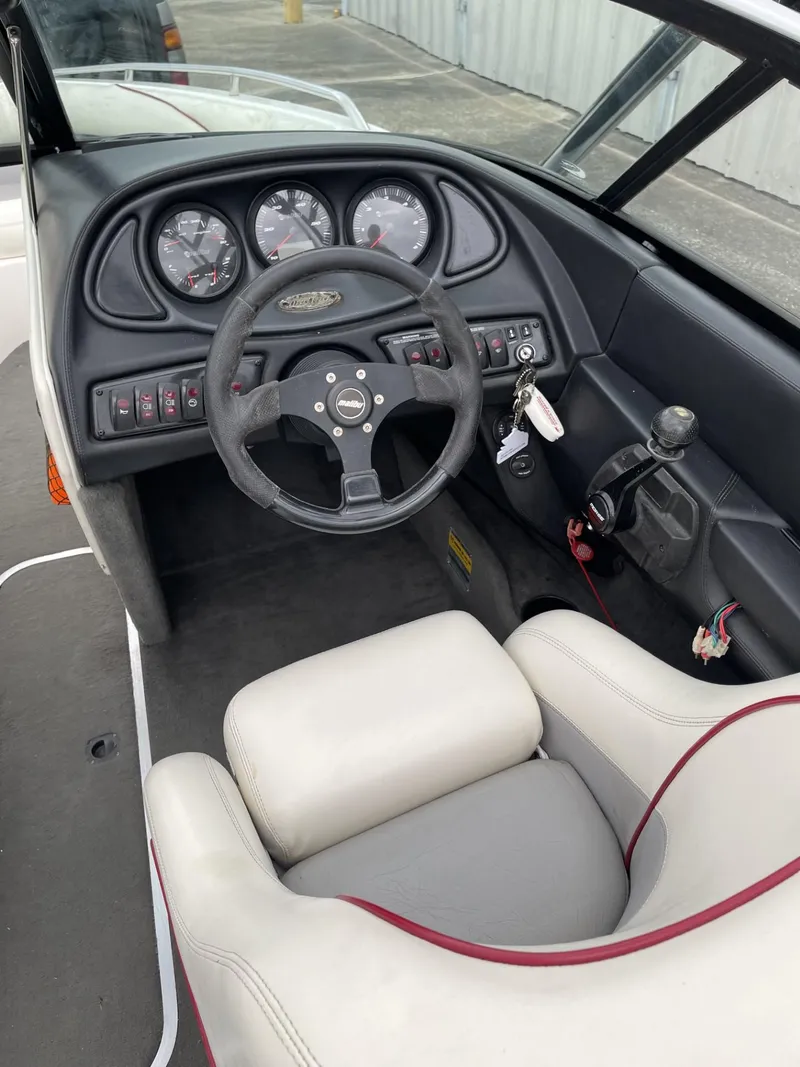Slide: The Image of 2003 Malibu Sunscape 21 LSV boat dashboard and steering wheel. - 19