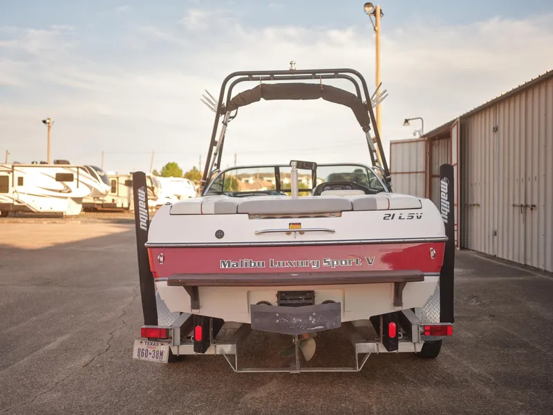 Slide: The Image of 2003 Malibu Sunscape 21 LSV boat rear view in a storage lot. - 2