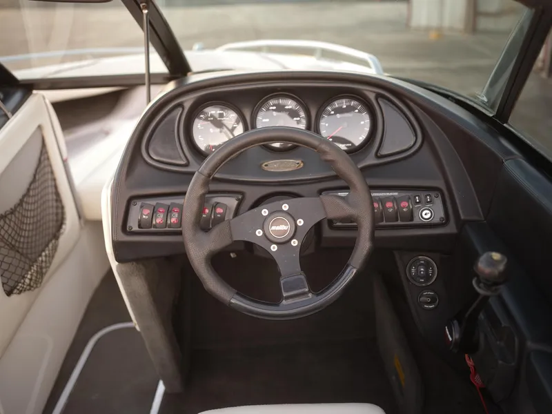 Slide: The Image of 2003 Malibu Sunscape 21 LSV boat dashboard with steering wheel and instrument panel. - 27
