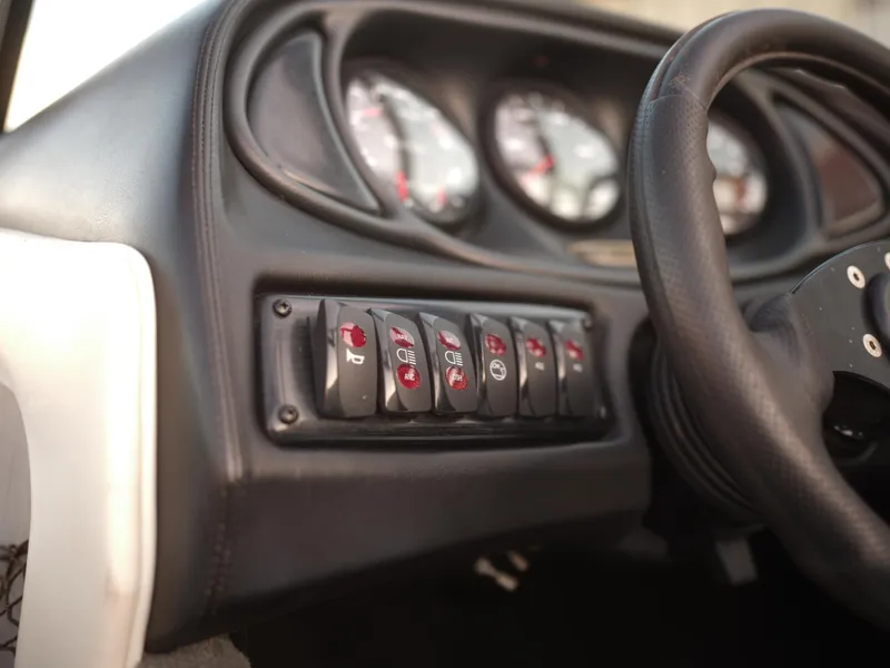 Slide: The Image of Dashboard controls of a 2003 Malibu Sunscape 21 LSV boat. - 28
