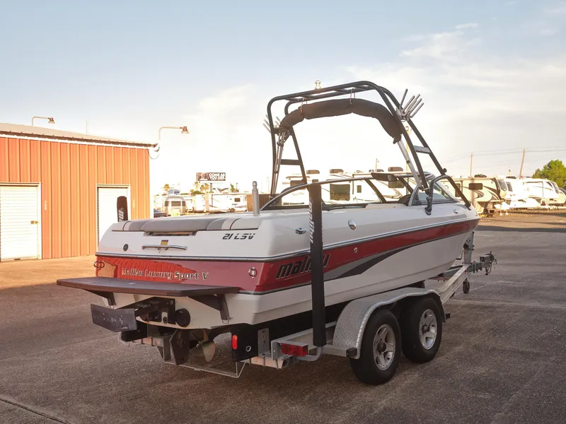 Slide: The Image of 2003 Malibu Sunscape 21 LSV boat on trailer in outdoor storage area. - 3