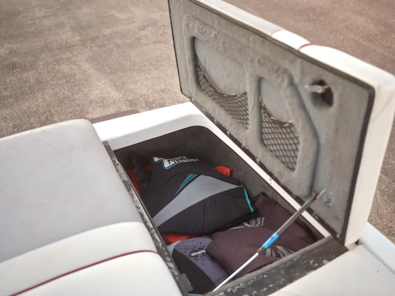 Slide: The Image of Storage compartment of a 2003 Malibu Sunscape 21 LSV boat with gear inside. - 31