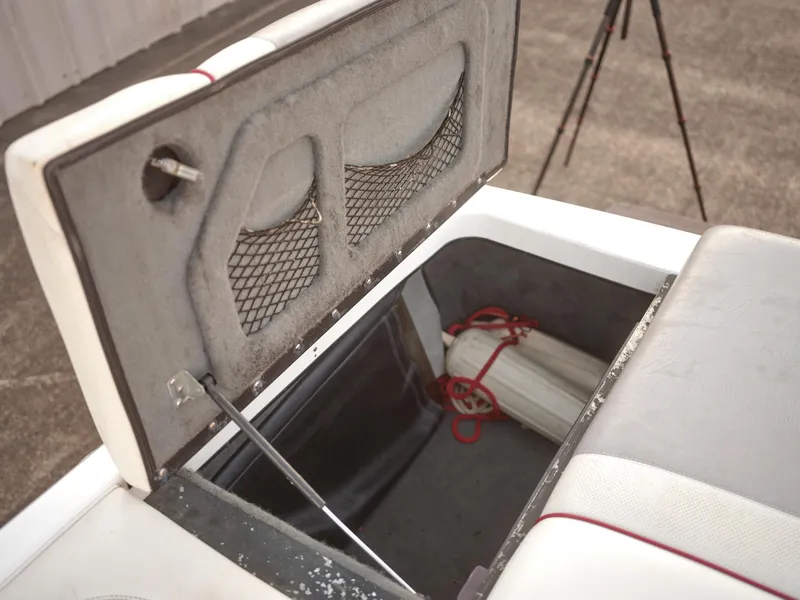 Slide: The Image of Open storage compartment in a 2003 Malibu Sunscape 21 LSV boat. - 32
