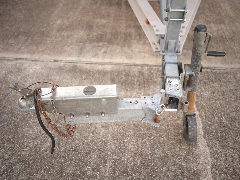 Slide: The Image of Trailer hitch of a 2003 Malibu Sunscape 21 LSV boat on concrete surface. - 38