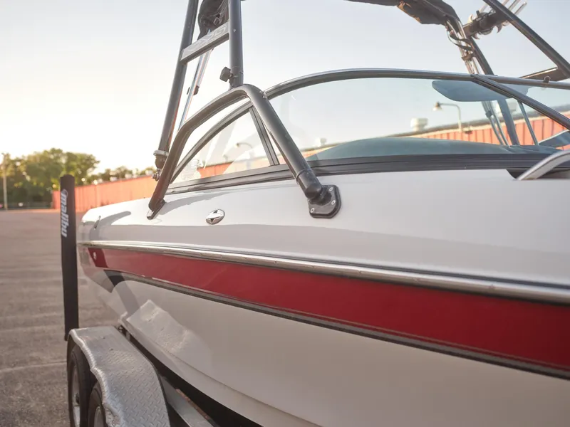 Slide: The Image of 2003 Malibu Sunscape 21 LSV boat with red stripe on trailer. - 6