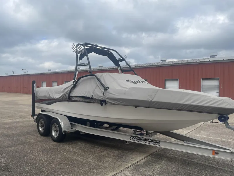 Slide: The Image of 2003 Malibu Sunscape 21 LSV boat on trailer with cover in storage lot. - 7