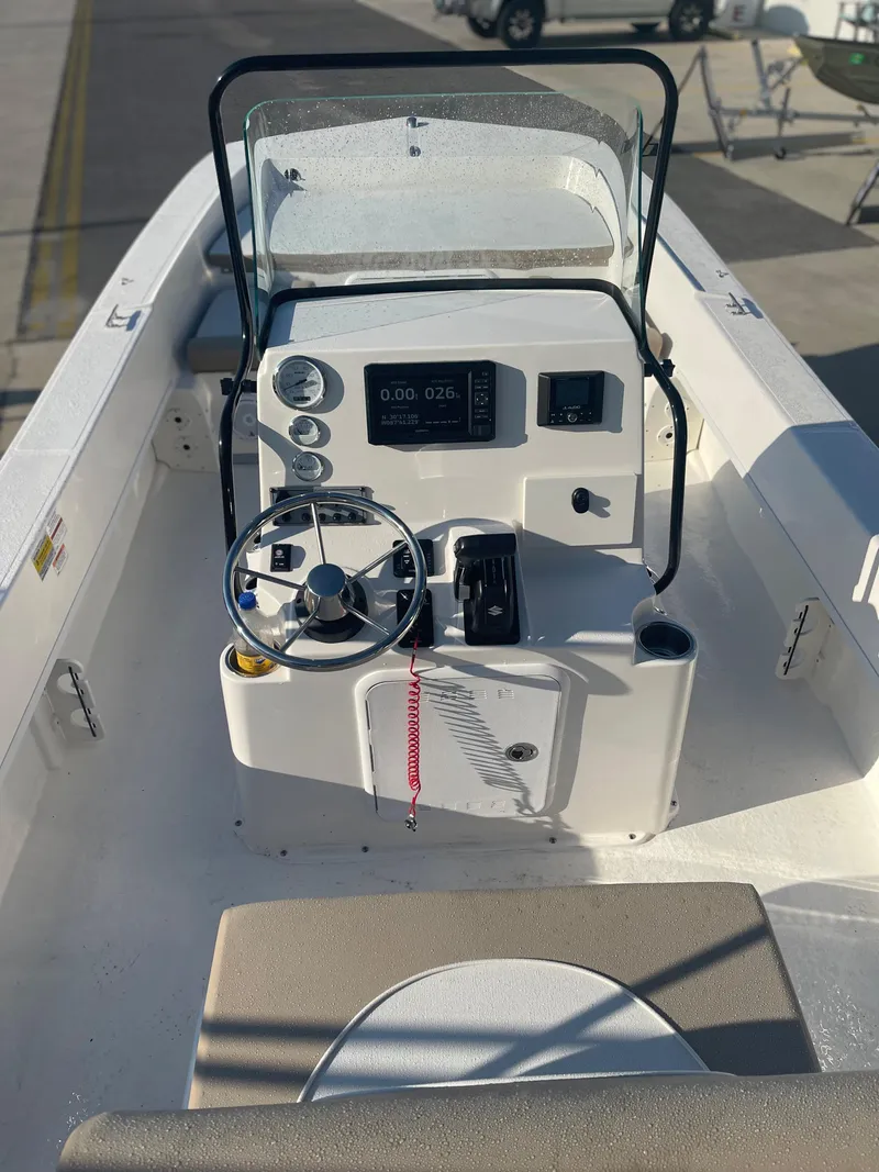 Slide: The Image of 2024 Sundance B20CCR center console boat with steering wheel and control panel. - 3