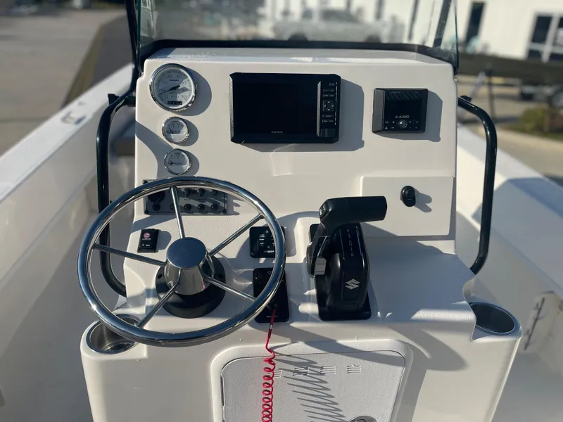 Slide: The Image of 2024 Sundance B20CCR boat console with steering wheel, gauges, and navigation system. - 4