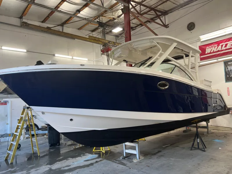 Slide: The Image of 2018 Robalo R317 Dual Console boat in a workshop. - 0