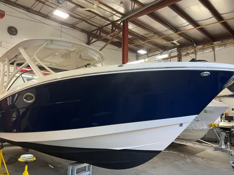 Slide: The Image of 2018 Robalo R317 Dual Console boat in a warehouse. - 1