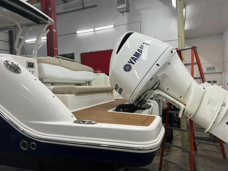 Slide: The Image of 2018 Robalo R317 Dual Console boat with Yamaha outboard motor in a workshop. - 11