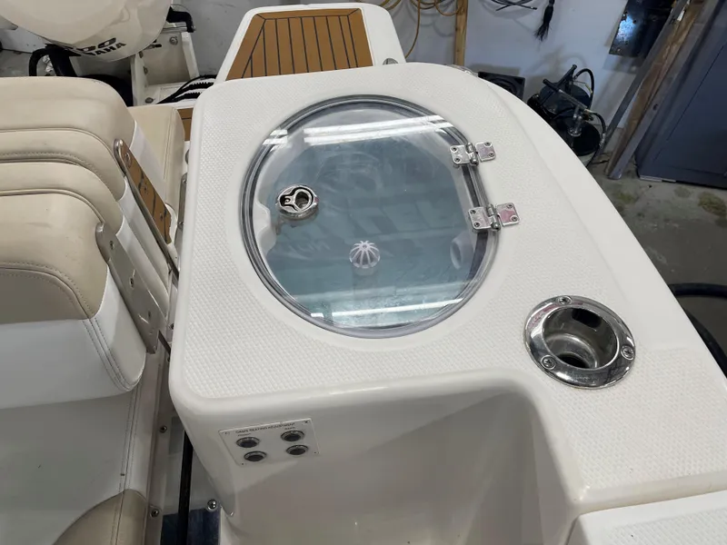Slide: The Image of 2018 Robalo R317 Dual Console boat interior with livewell and seating. - 13