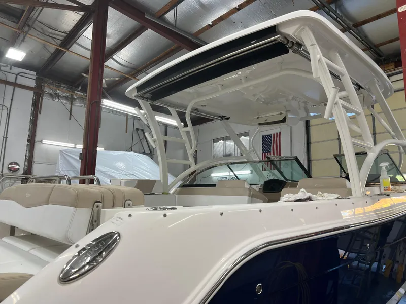 Slide: The Image of 2018 Robalo R317 Dual Console boat in a warehouse. - 14