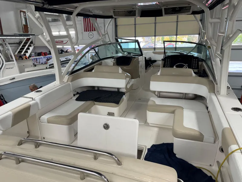 Slide: The Image of 2018 Robalo R317 Dual Console boat interior with beige seating and modern dashboard. - 3