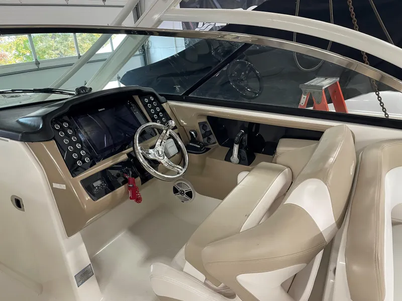 Slide: The Image of 2018 Robalo R317 Dual Console boat interior with steering wheel and control panel. - 4