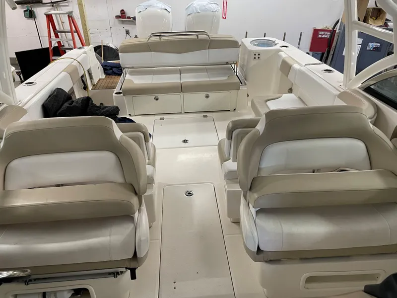 Slide: The Image of 2018 Robalo R317 Dual Console boat interior with beige seating and spacious layout. - 5