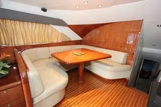 Slide: The Image of Luxurious interior of a 2001 Precision Convertible yacht with wooden finishes and plush seating. - 11