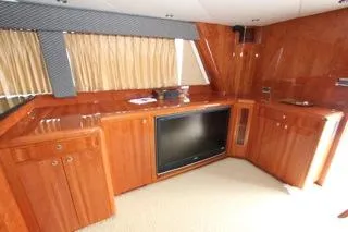 Slide: The Image of Luxurious wooden interior of a 2001 Precision Convertible yacht with built-in TV. - 13
