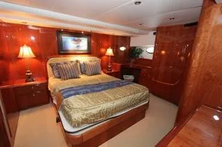 Slide: The Image of Luxurious bedroom in a 2001 Precision Convertible yacht with elegant wood finishes. - 15