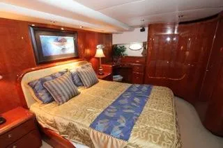 Slide: The Image of Luxurious bedroom in a 2001 Precision Convertible yacht with elegant wood finishes. - 17