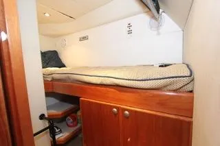 Slide: The Image of 2001 Precision Convertible boat interior with cozy bunk bed and wooden storage cabinets. - 18