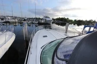 Slide: The Image of 2001 Precision Convertible yacht docked at a marina with other boats. - 2