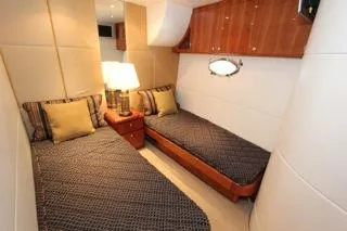 Slide: The Image of 2001 Precision Convertible yacht twin bed cabin interior with wooden accents and bedside lamp. - 20