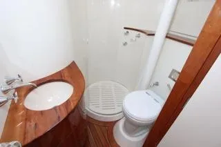 Slide: The Image of Compact bathroom in a 2001 Precision Convertible boat with wooden accents. - 21