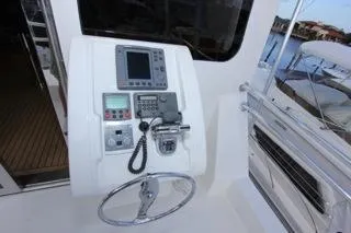 Slide: The Image of 2001 Precision Convertible boat control panel with steering wheel and navigation equipment. - 4