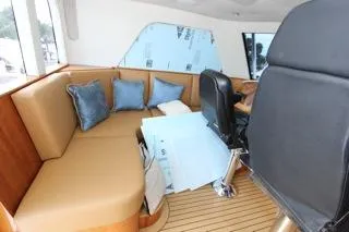Slide: The Image of Interior of a 2001 Precision Convertible boat with seating and helm chair. - 9