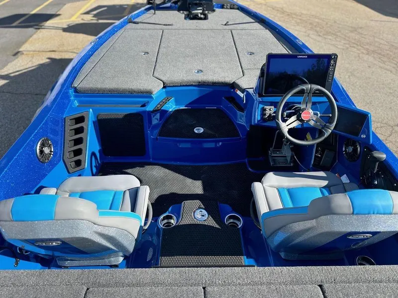 Slide: The Image of 2024 iKon LX 20 boat interior with blue and gray seats, steering wheel, and dashboard. - 10