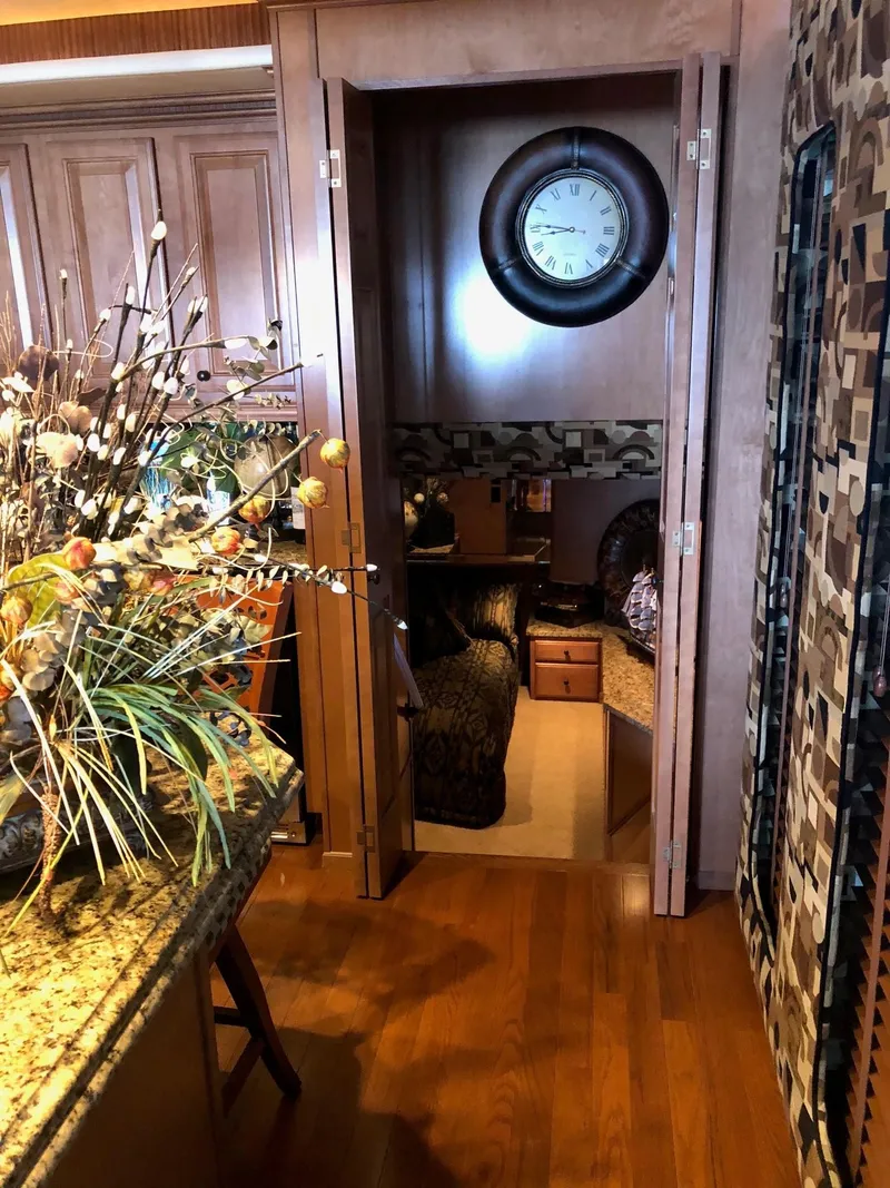 Slide: The Image of Interior of a 2008 Sumerset Houseboat 20' x 100' with wooden flooring and a cozy bedroom. - 10