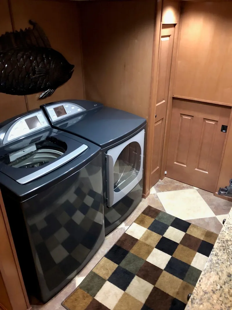 Slide: The Image of Laundry area in 2008 Sumerset Houseboat with washer, dryer, and checkered rug. - 14