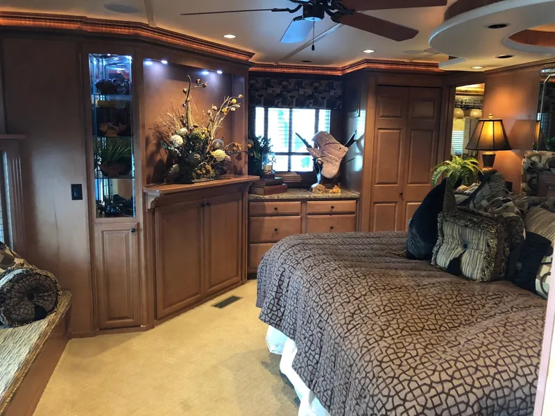 Slide: The Image of Luxurious bedroom interior of a 2008 Sumerset Houseboat 20' x 100' with elegant wooden cabinetry. - 22