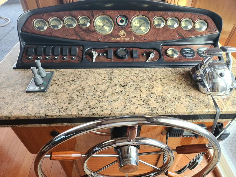 Slide: The Image of Control panel of a 2008 Sumerset Houseboat 20' x 100' with steering wheel and gauges. - 25